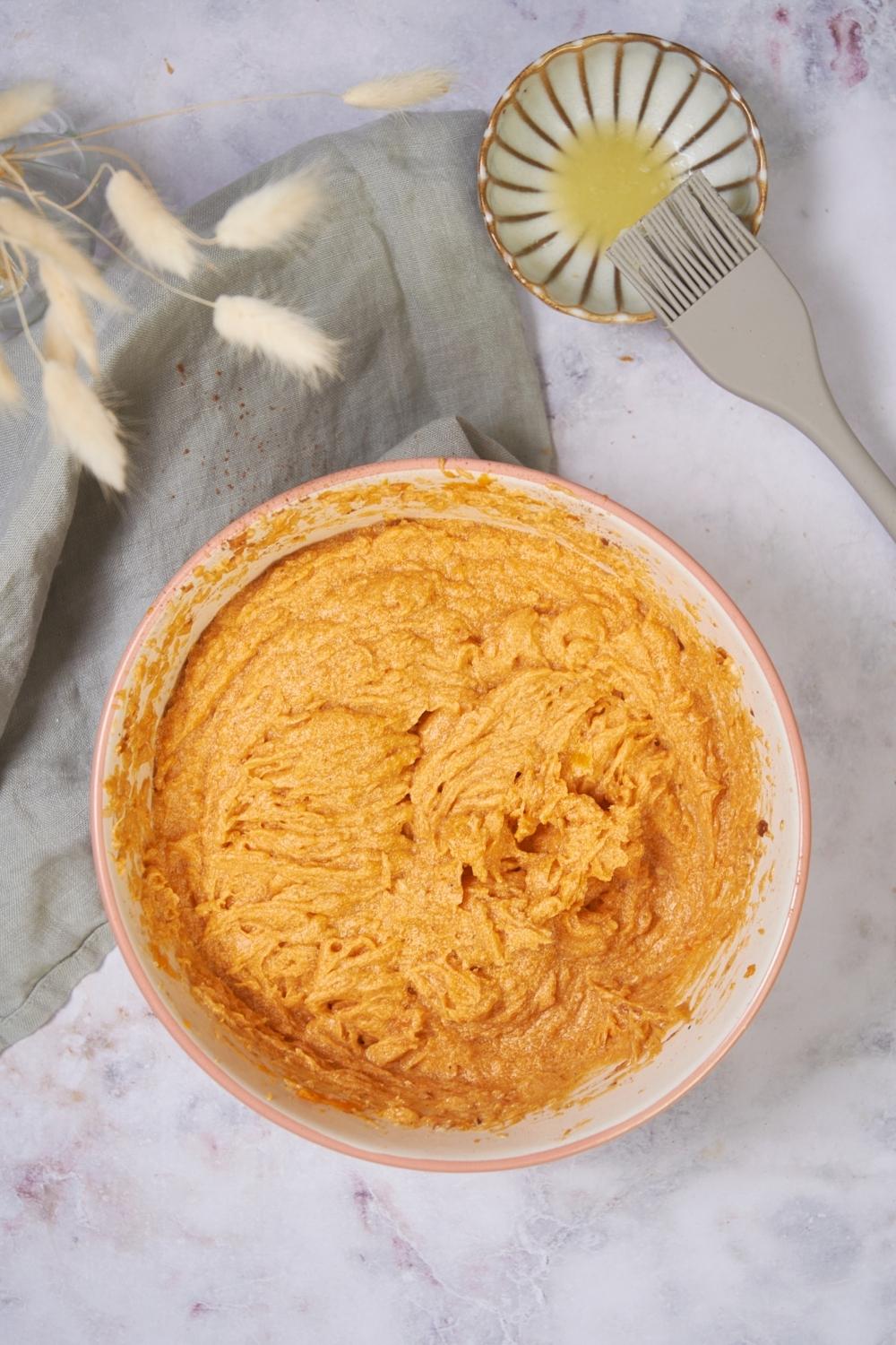 A large mixing bowl of sweet potato pie filling.