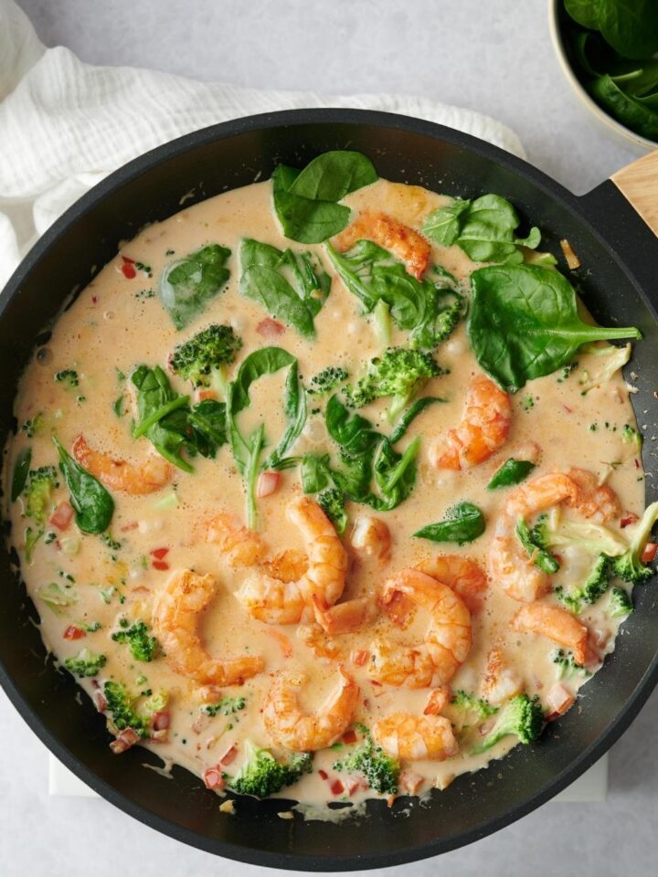 A hot pan with homemade curry shrimp in it.