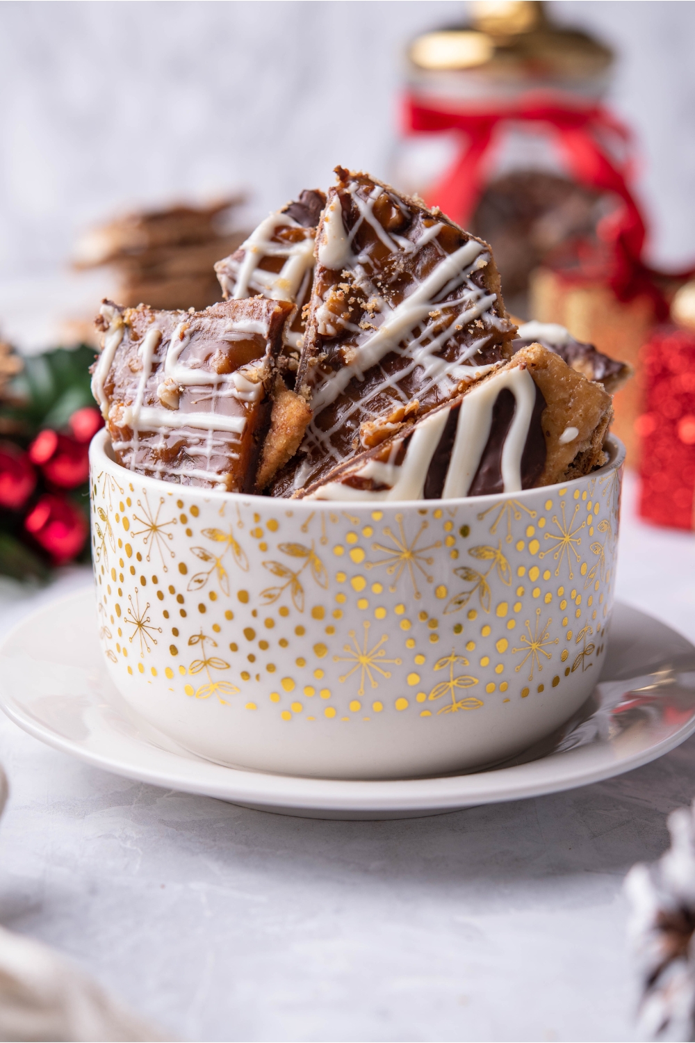 White and gold bowl filled with Christmas cracker candy.