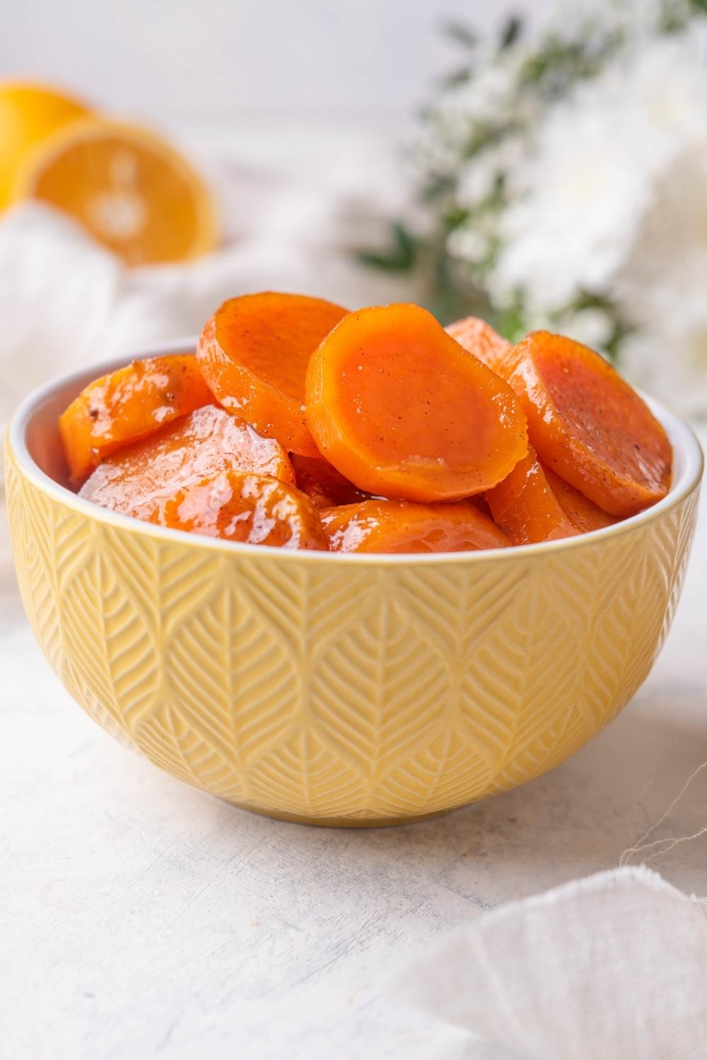 A bowl with candied yams in it.