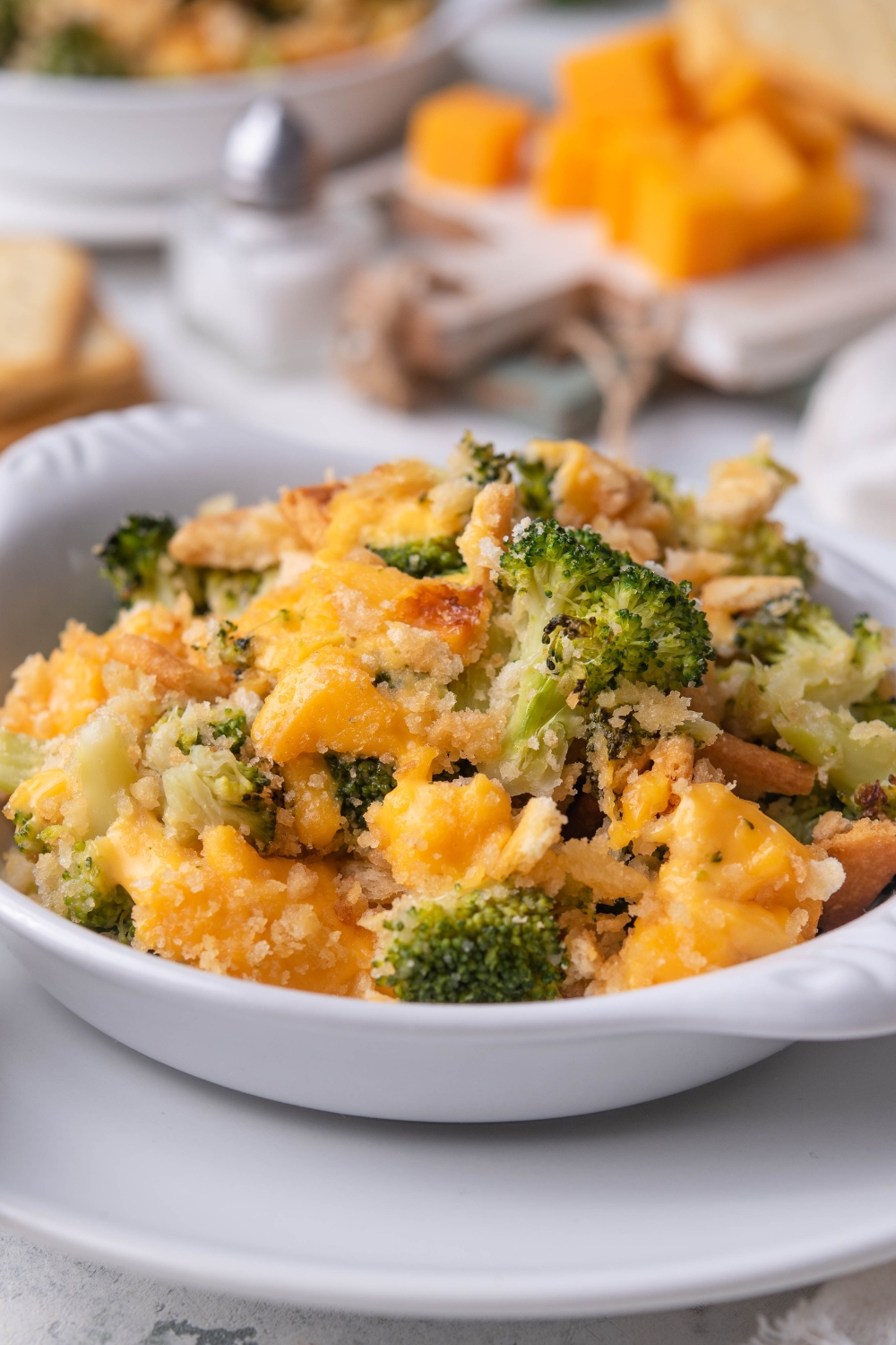 A dish containing cheddars broccoli cheese casserole.