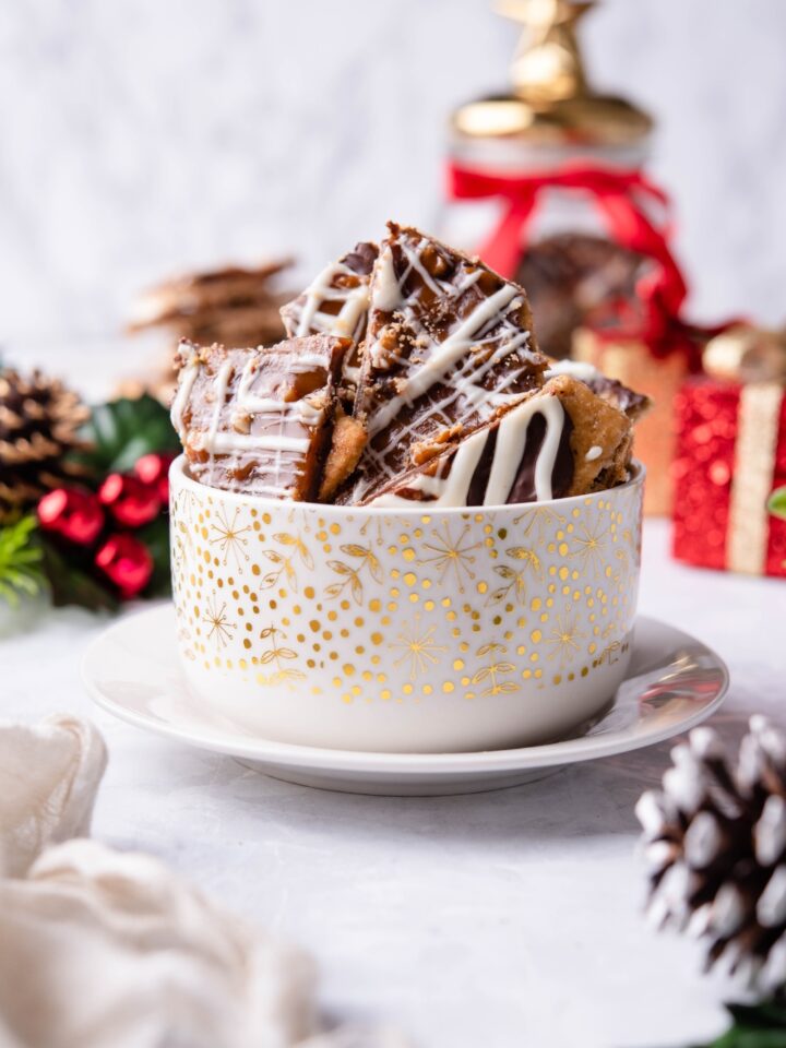 White and gold bowl filled with Christmas cracker candy.