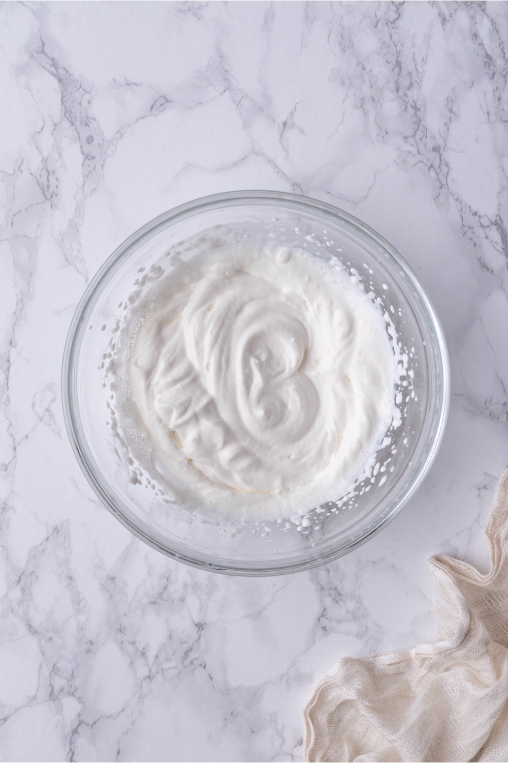Clear bowl of freshly whipped cream.