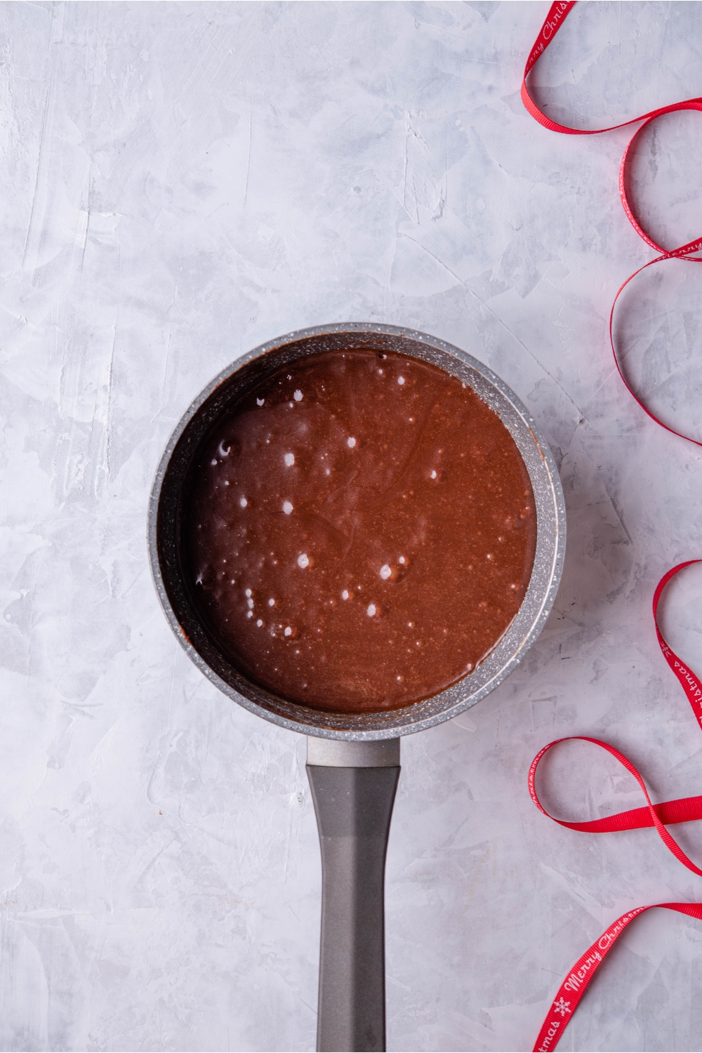 Saucepan filled with chocolate fudge batter.