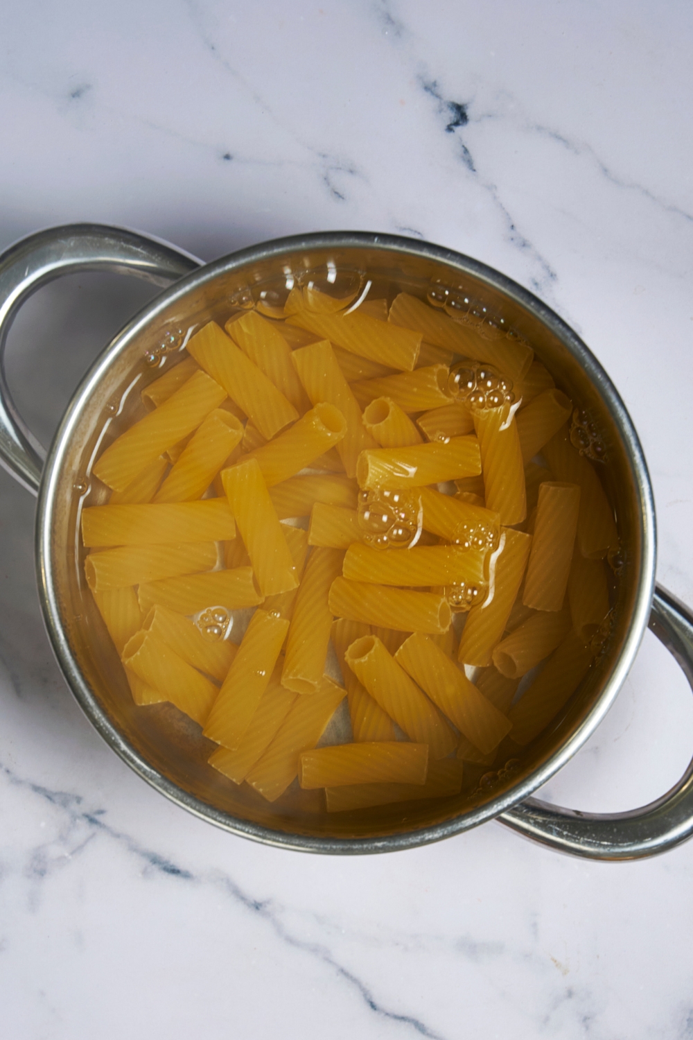 A pot with boiling water cooking pasta.