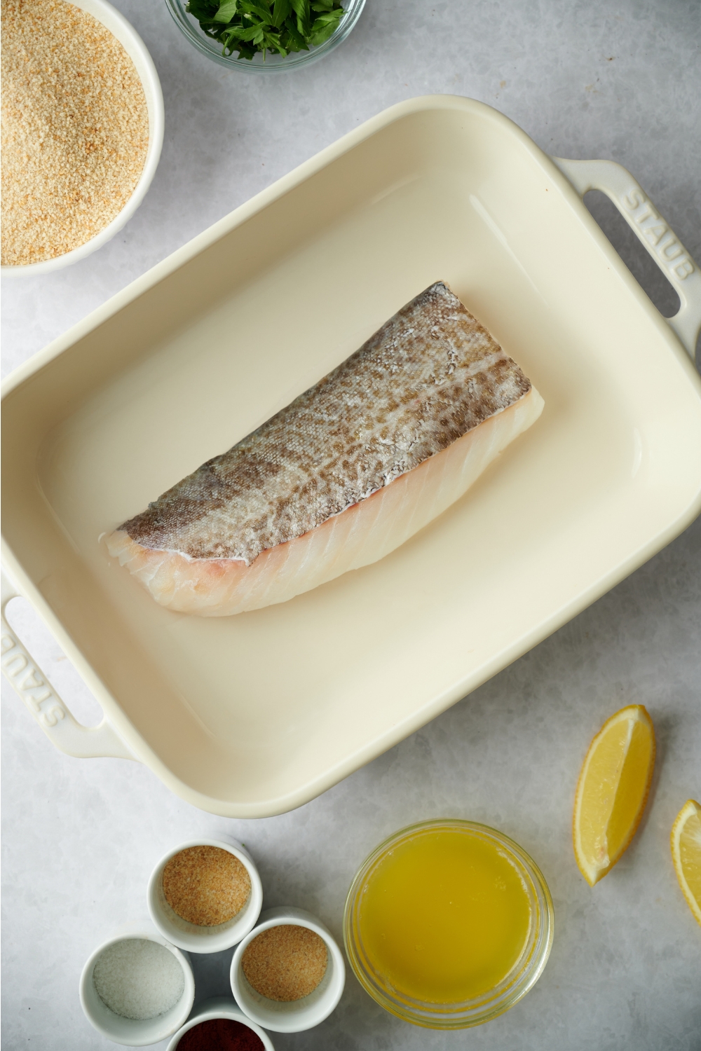 A haddock fillet in a baking dish.