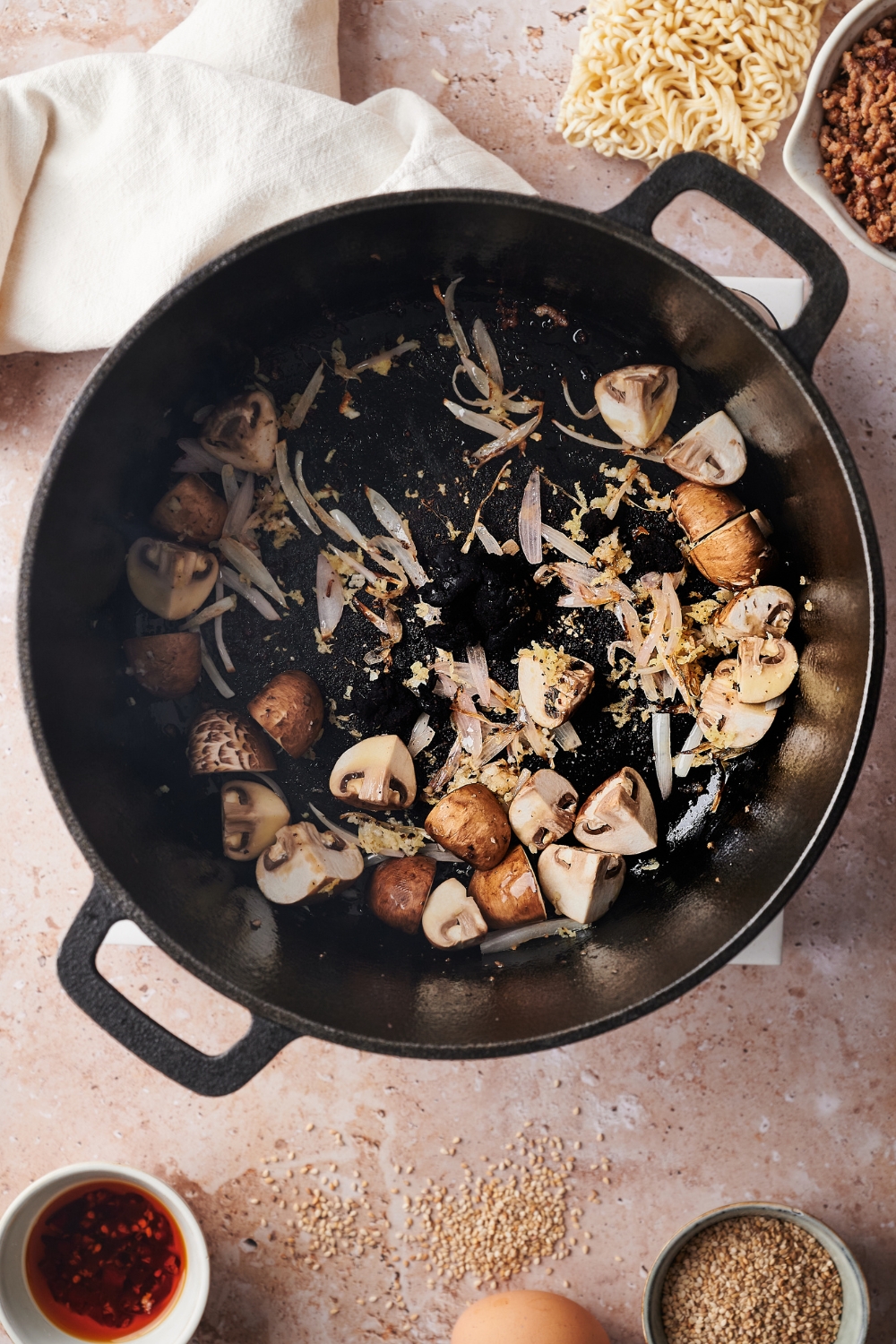 Mushrooms, garlic, and onion cooking in a large pot.
