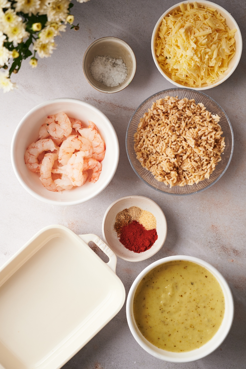 Various bowls on the countertop with the ingredients to make shrimp casserole.