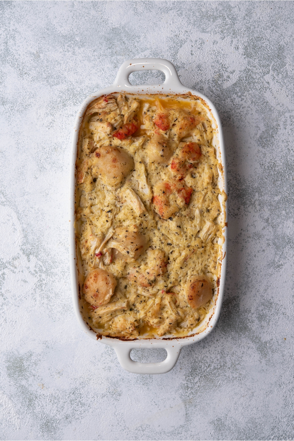 Seafood casserole in a white baking dish.