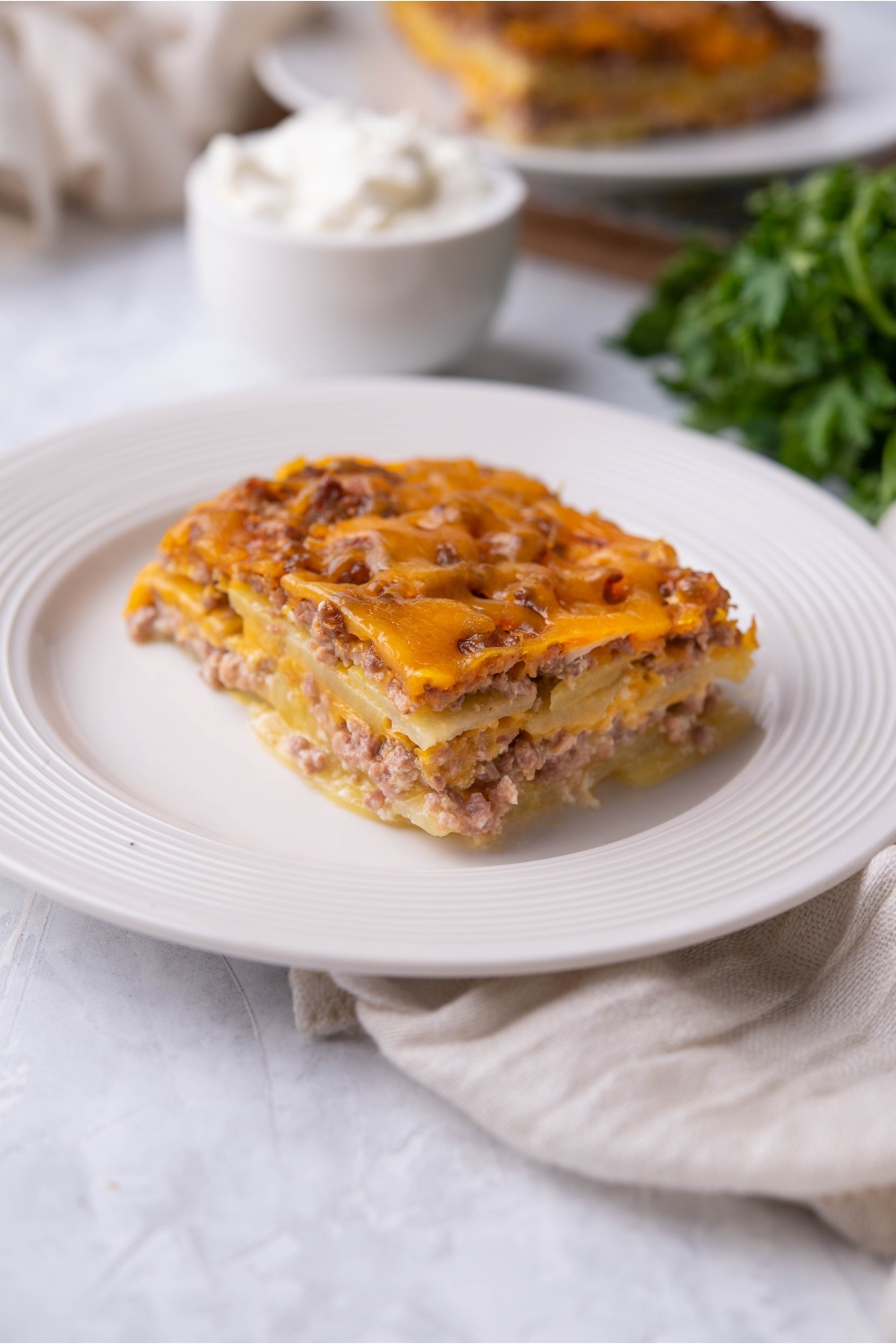 Single serving of hamburger potato casserole on a white plate.