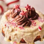 Peppermint cheesecake topped with chocolate frosting and crushed candy canes.