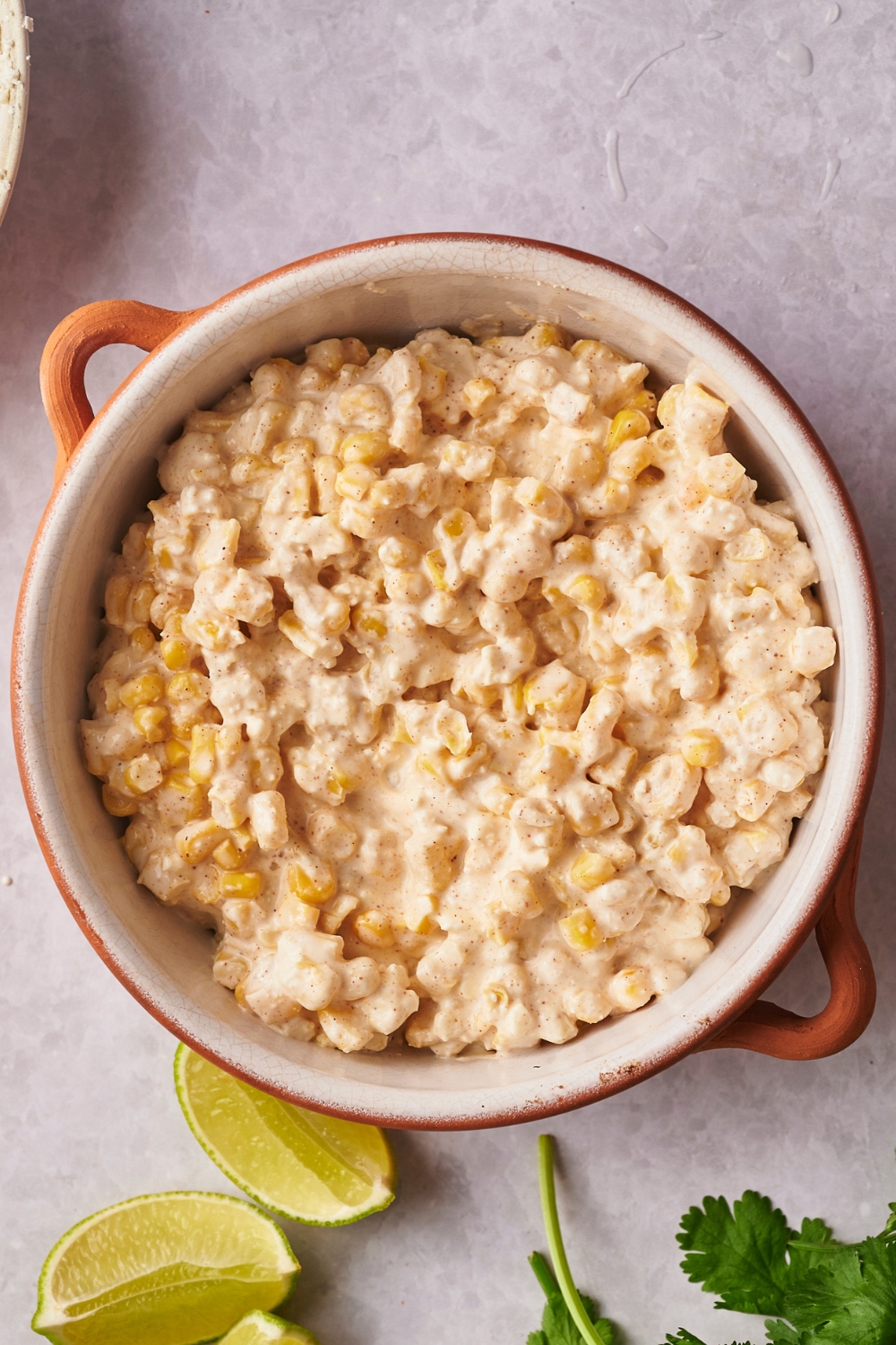 A casserole dish with the corn mixture in it.