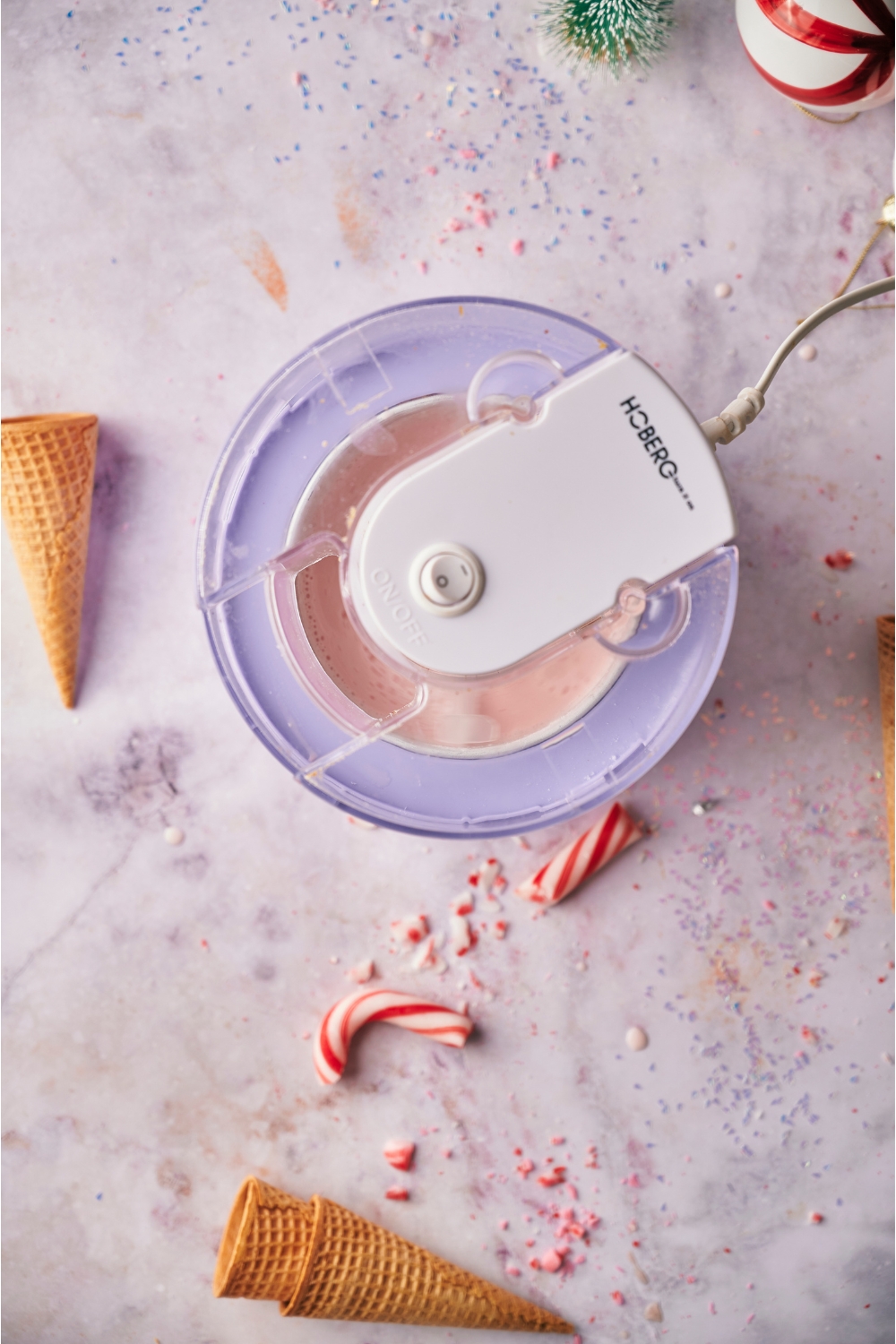 Ice cream maker with the lid on making peppermint ice cream.