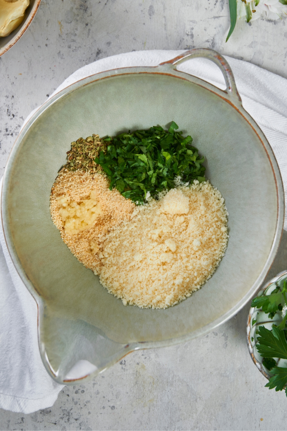 A bowl with bread crumbs, parmesan cheese and seasonings.
