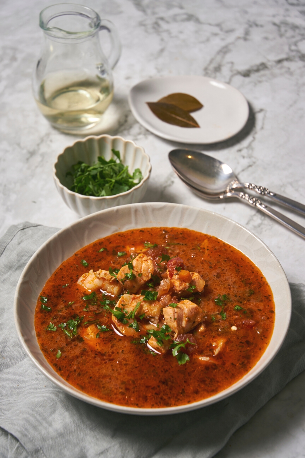 Shrimp and salmon on top of soup in a bowl.