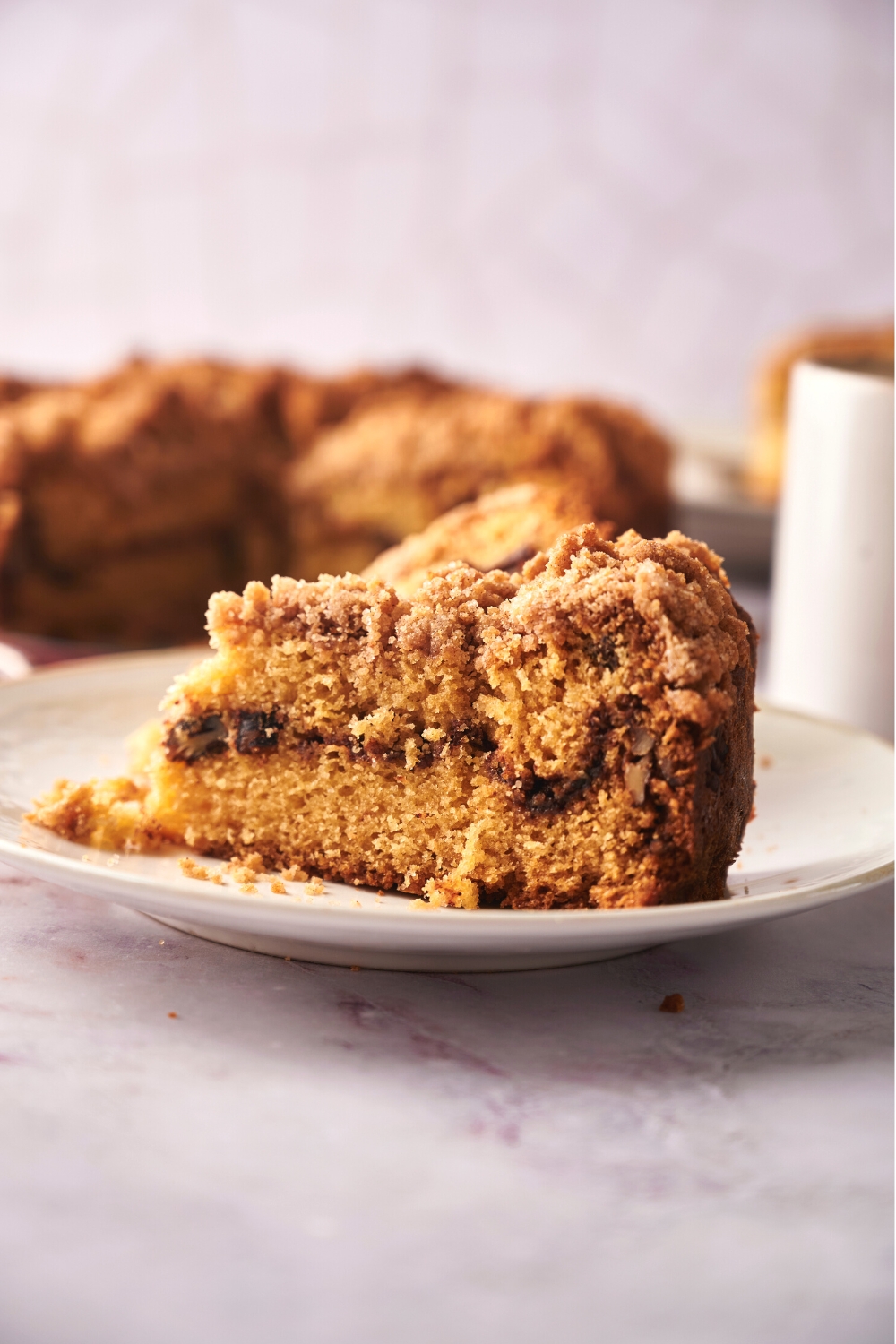 A slice of coffee cake on a white plate.