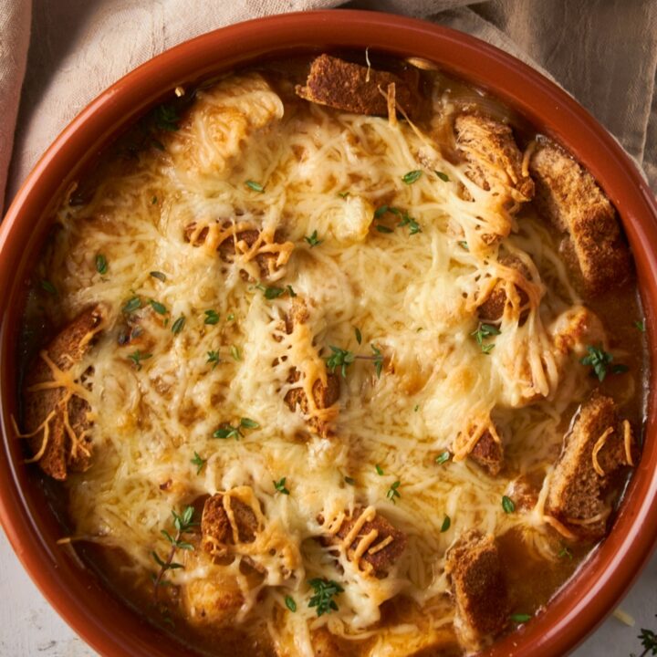 Mozzarella cheese on top of French onion chicken bake in a bowl.