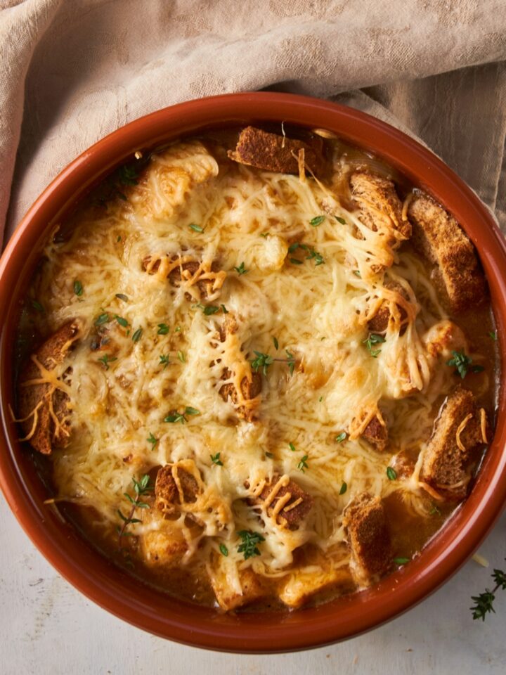Mozzarella cheese on top of French onion chicken bake in a bowl.