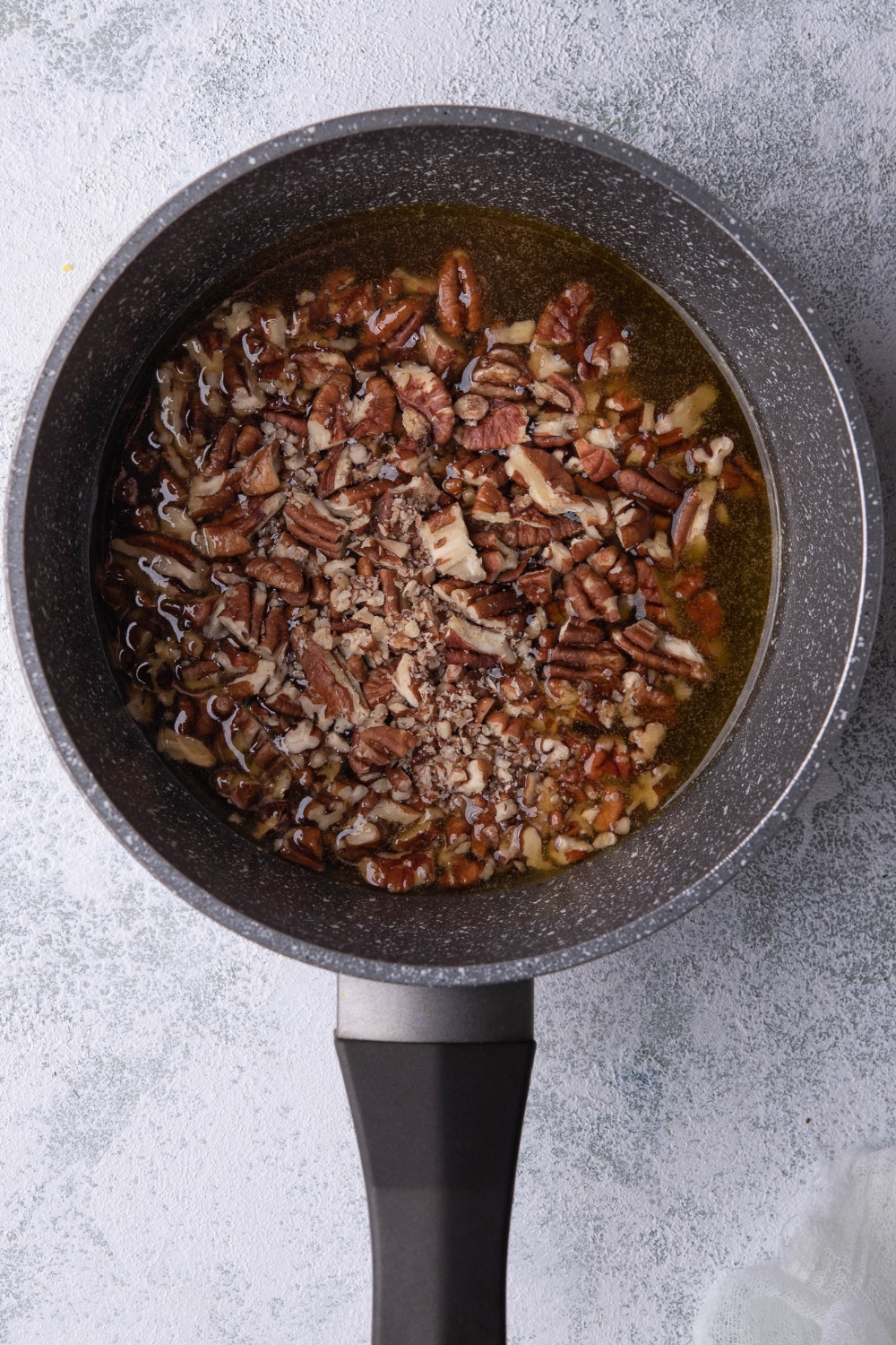 A pot with pecan topping in it.