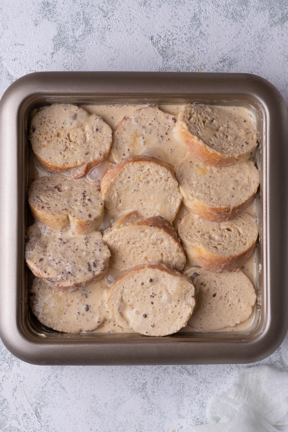 A pan with uncooked french toast casserole.