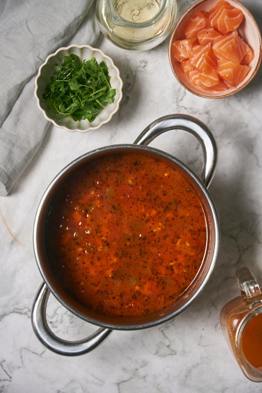 A pot that is filled with a tomato broth.