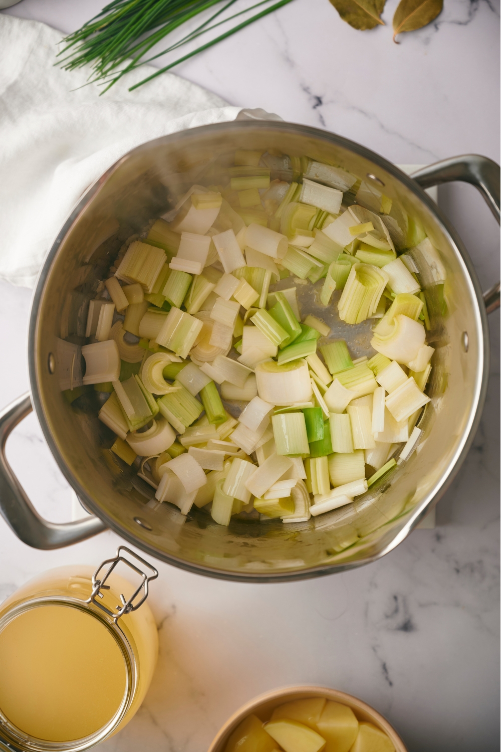 Chopped leeks cooking in a pot.