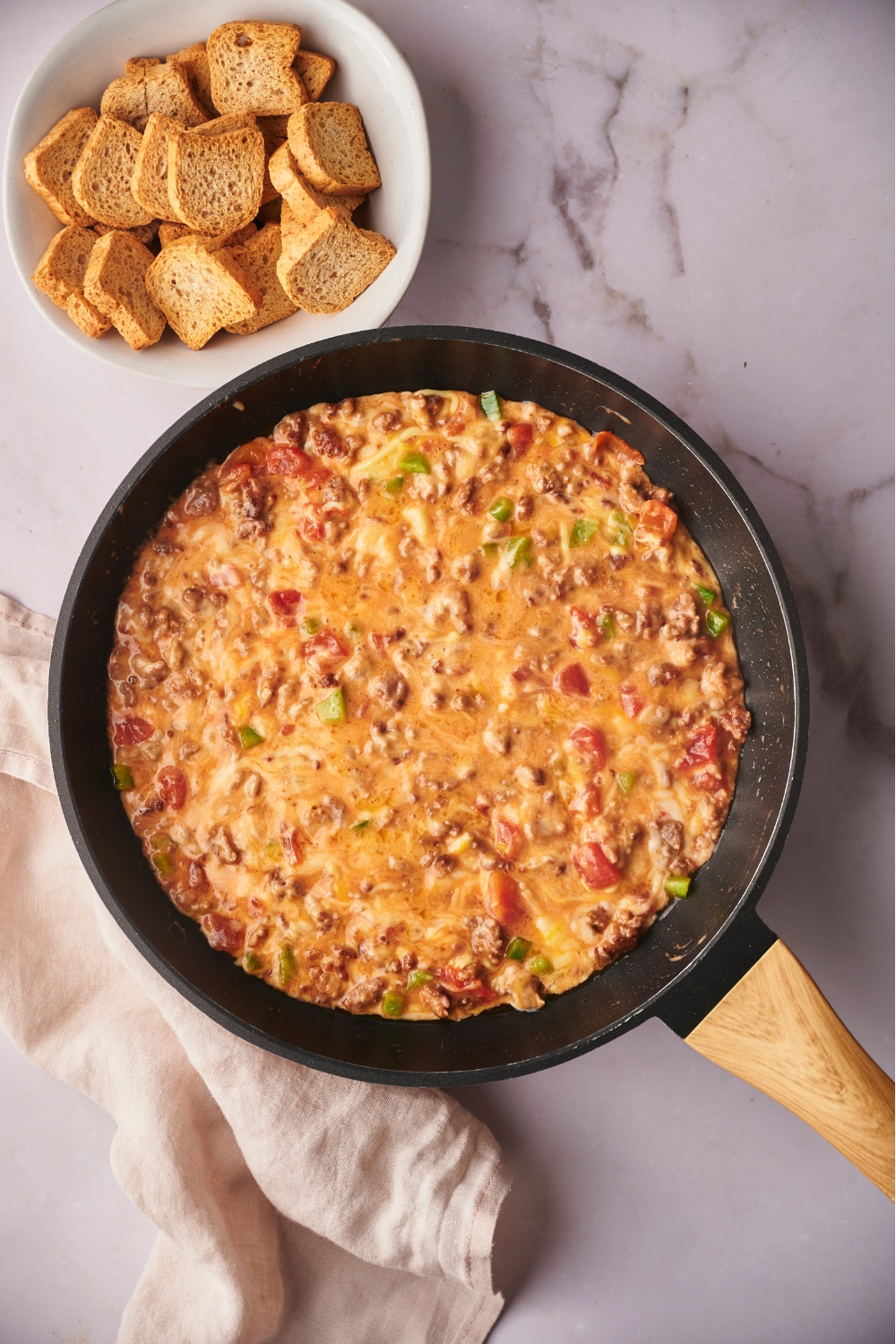 Rotel dip cooking in a skillet.