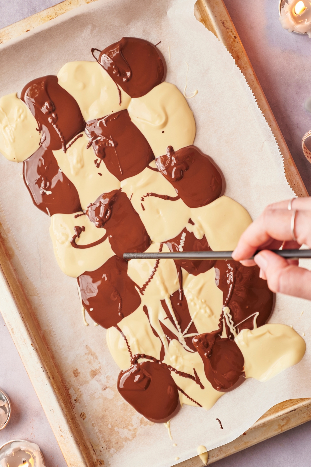 Melted chocolate in a checkered pattern on parchment paper.