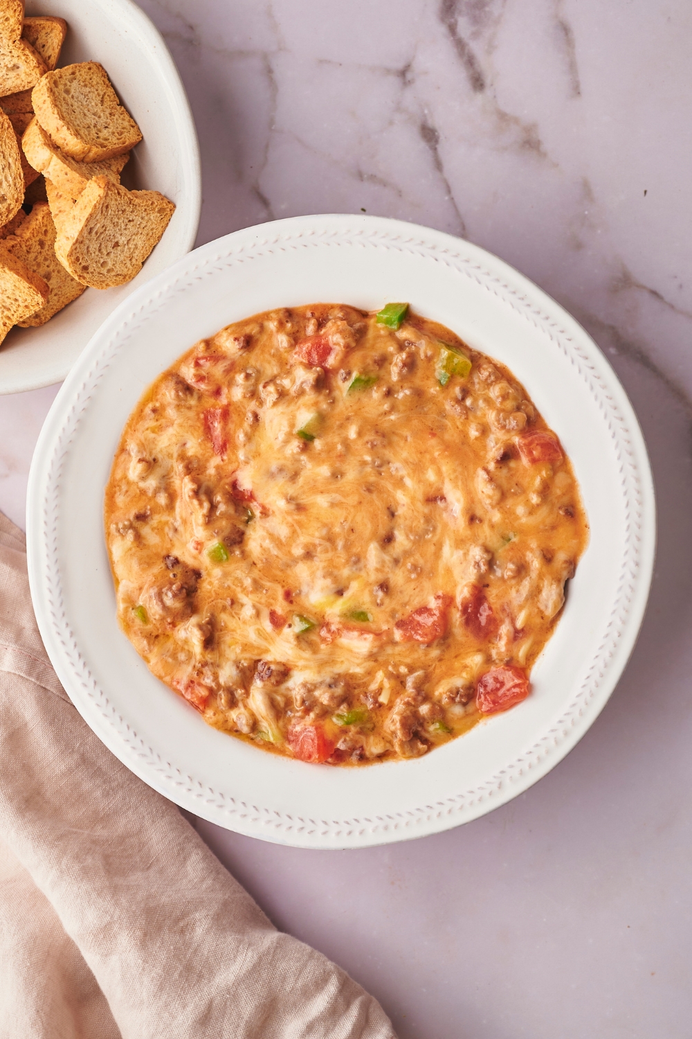 Rotel dip in a white bowl on a white counter.