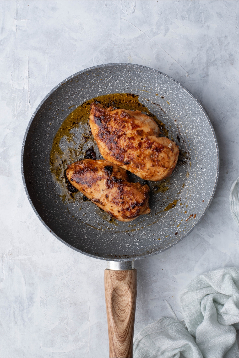 Chipotle chicken cooking in a skillet with oil.