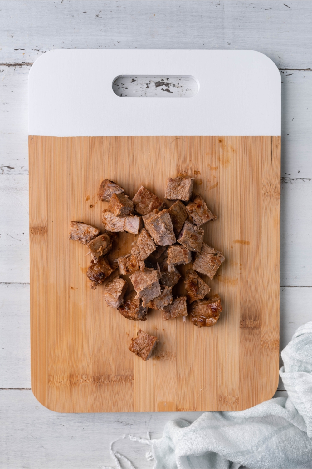 Cubed steak on a cutting board.