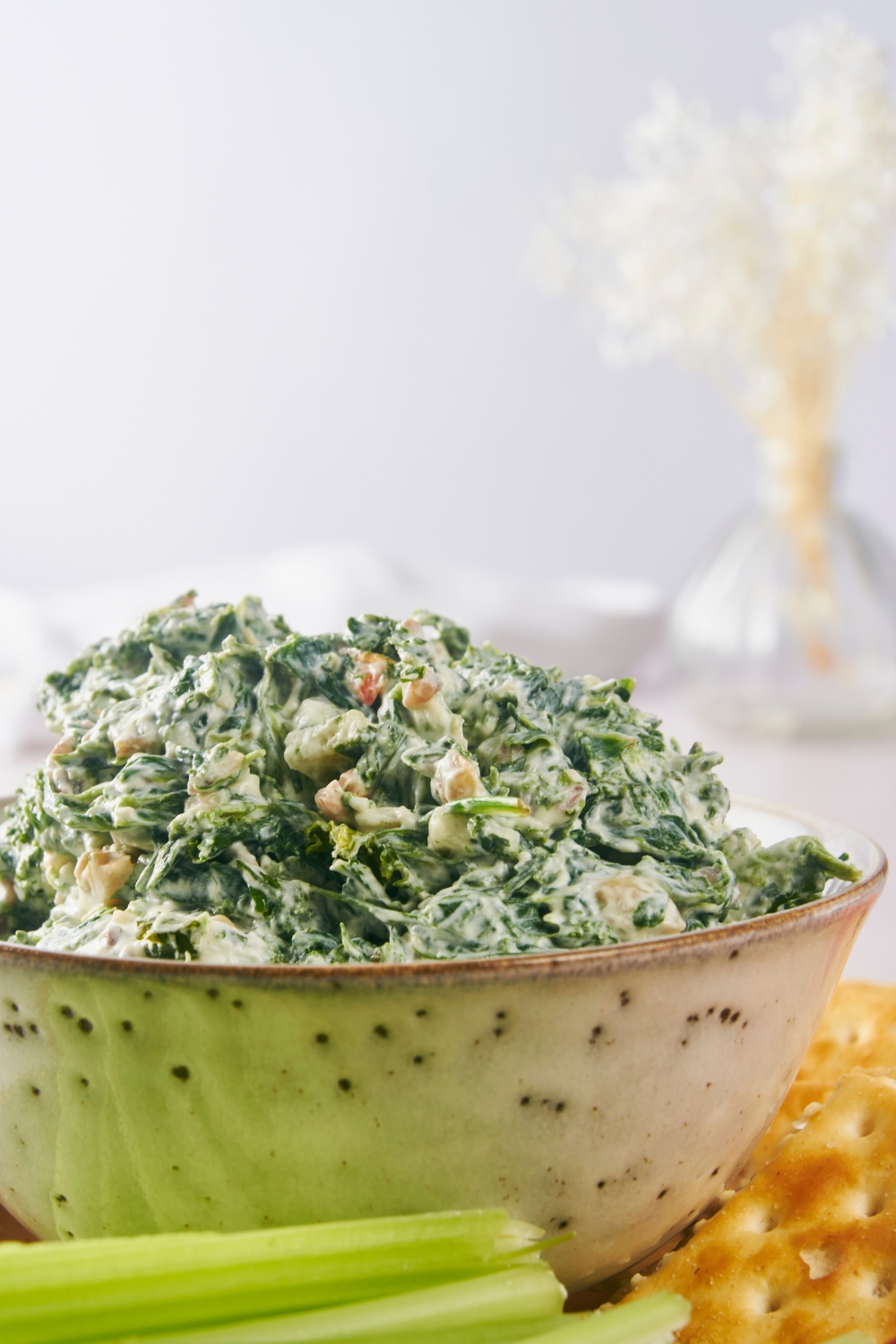 A serving bowl with spinach dip.