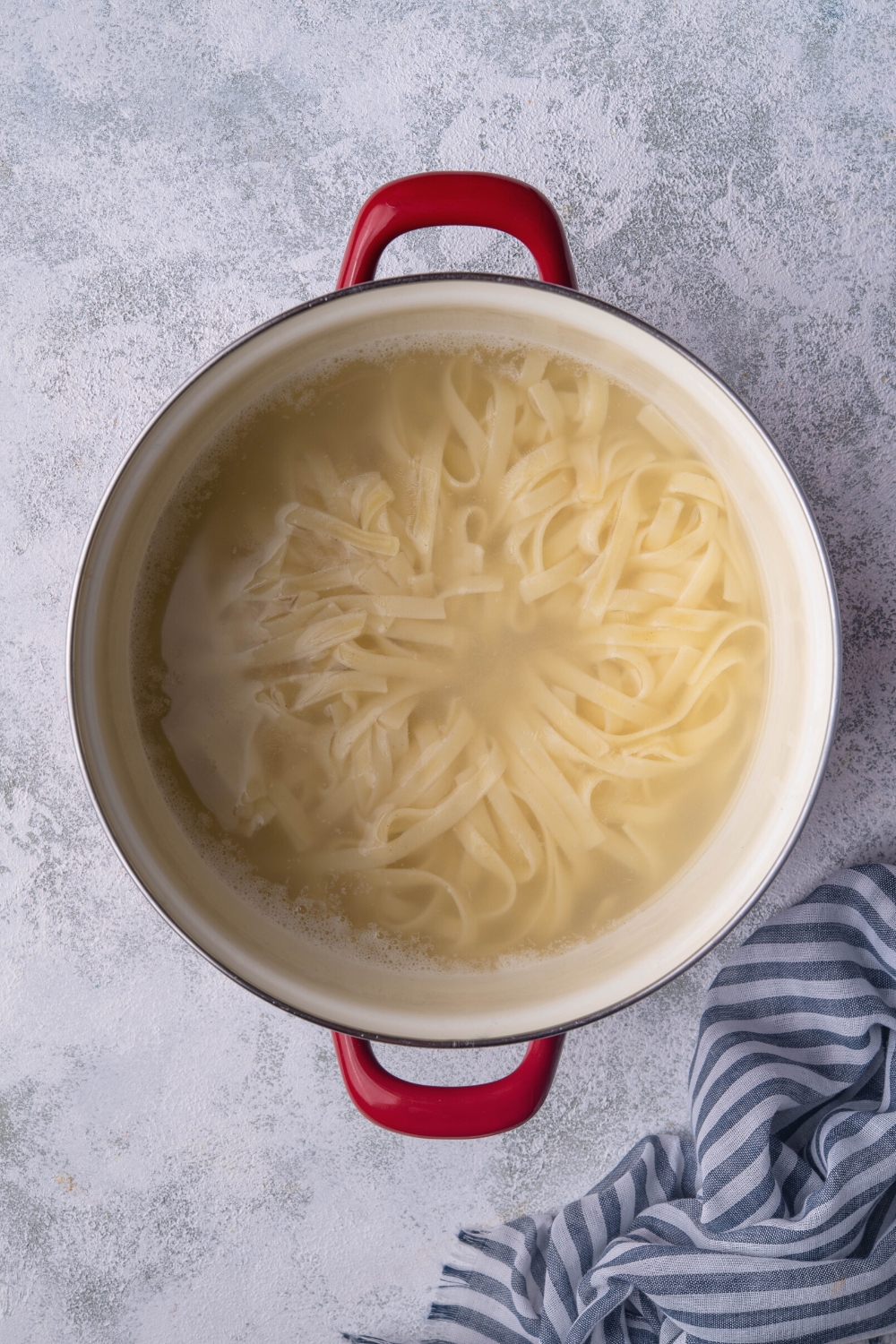 Pasta noodles in a pot of water.