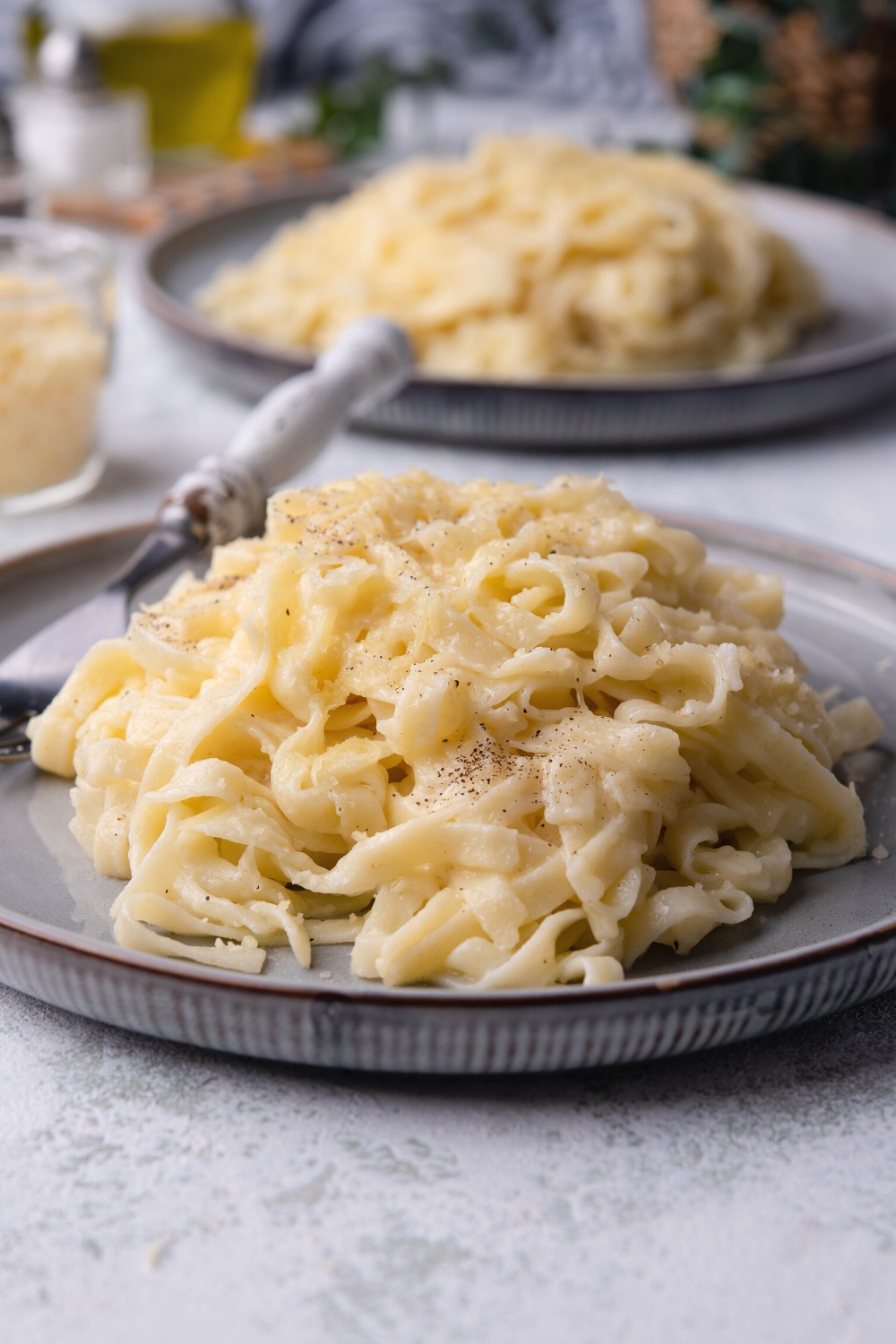 A pile of buttered noodles on a plate.