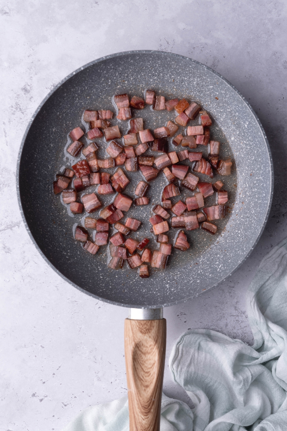 Pancetta cooking in a pan.