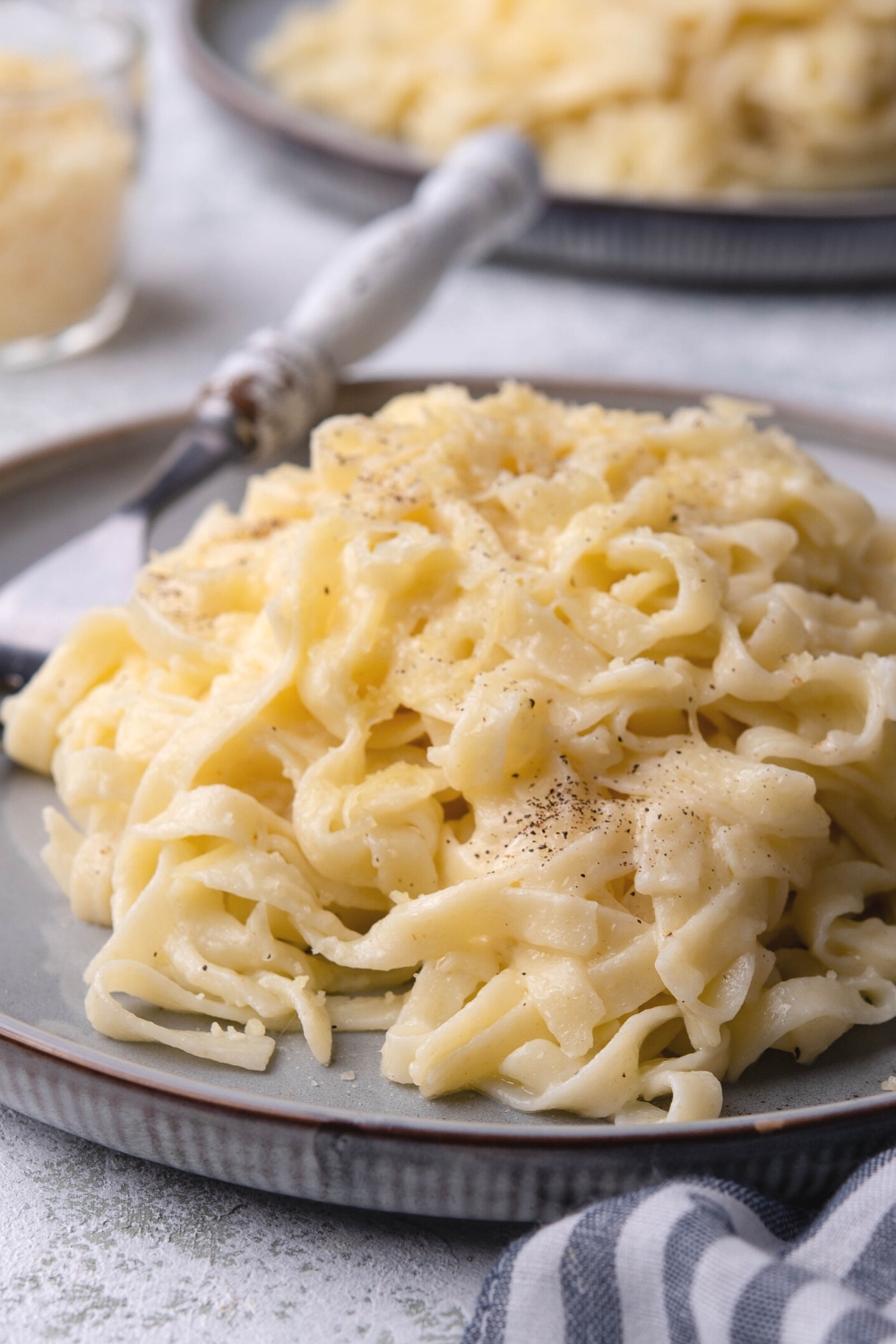 Parmesan noodles on part of a plate.