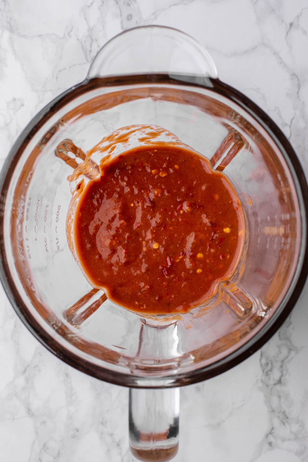 A blender with smooth hot salsa in it.