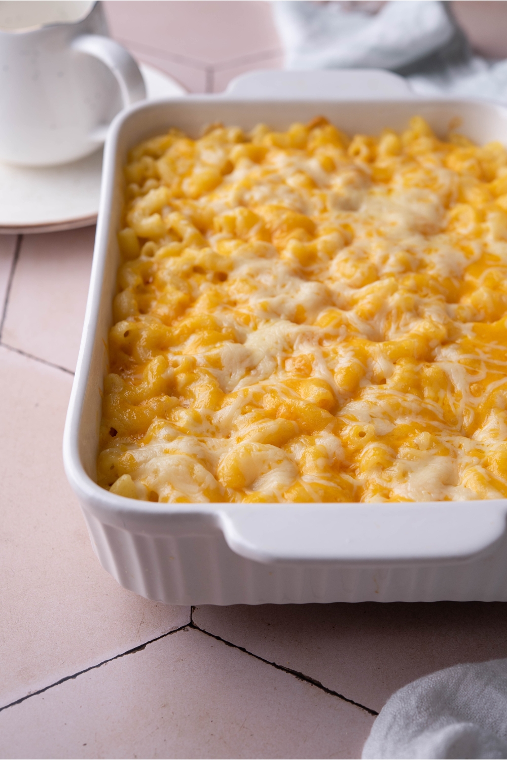 A white baking dish filled with baked Chick Fil A macaroni and cheese.