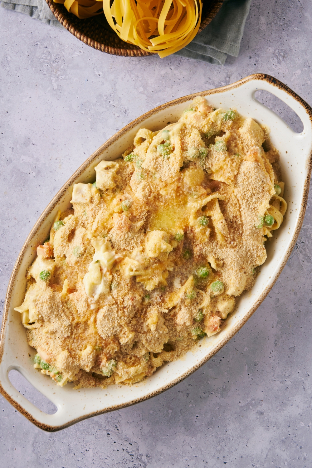 A casserole dish with unbaked chicken noodle casserole in it.