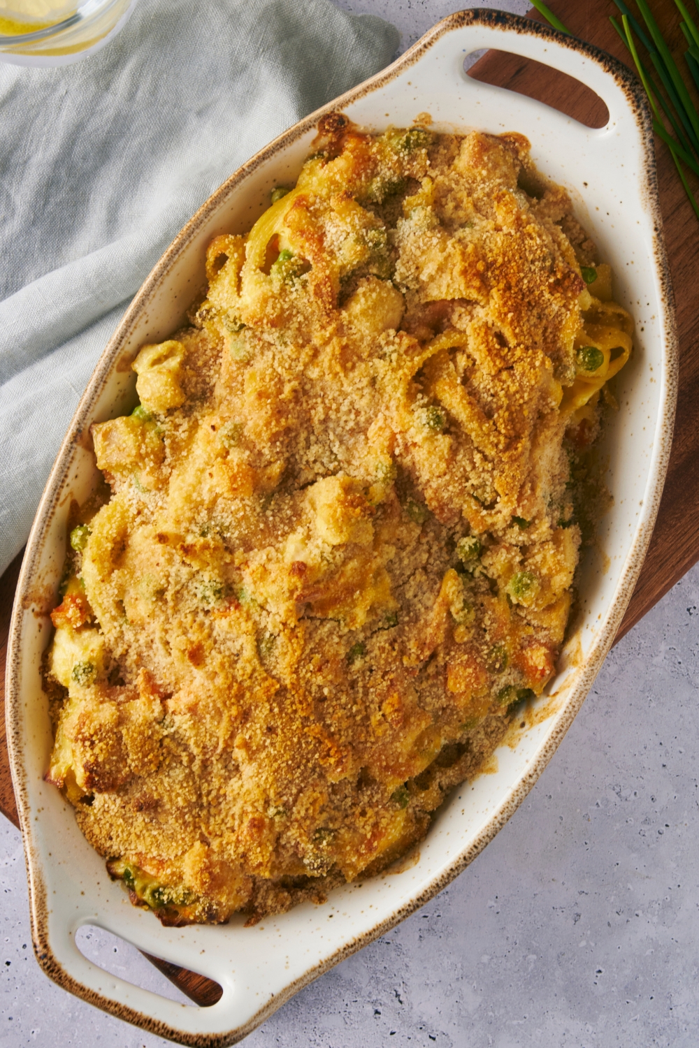A casserole dish with chicken noodle casserole baked to golden brown.