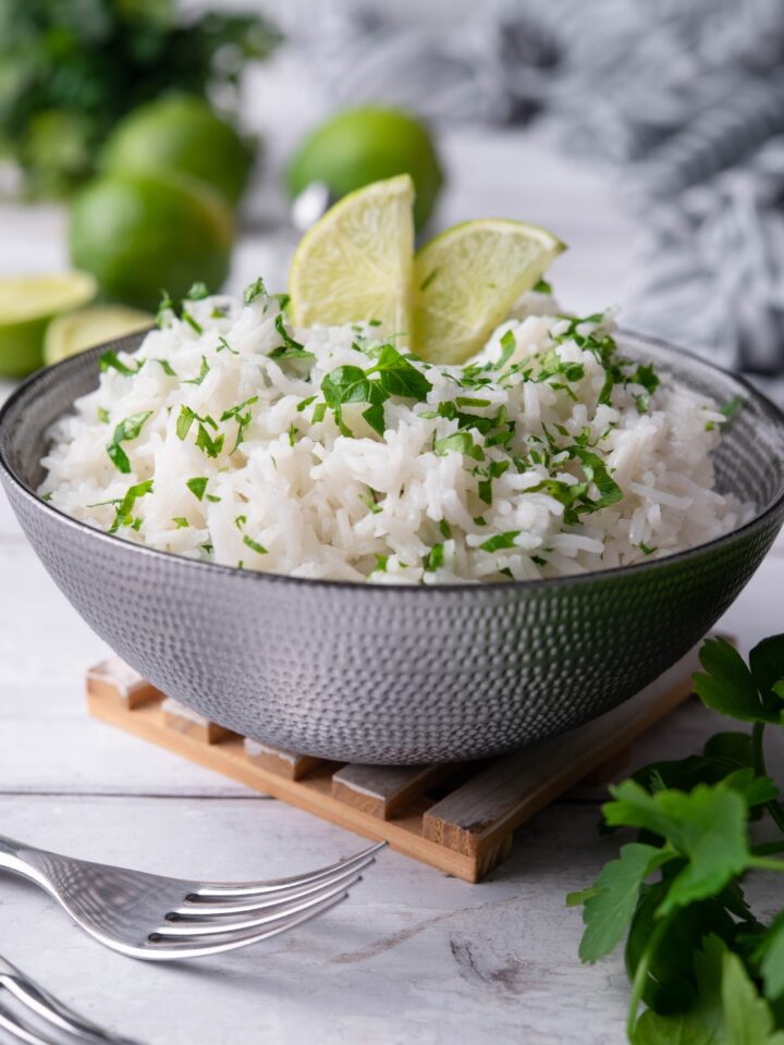 Two limes on top of cilantro lime rice in a bowl.