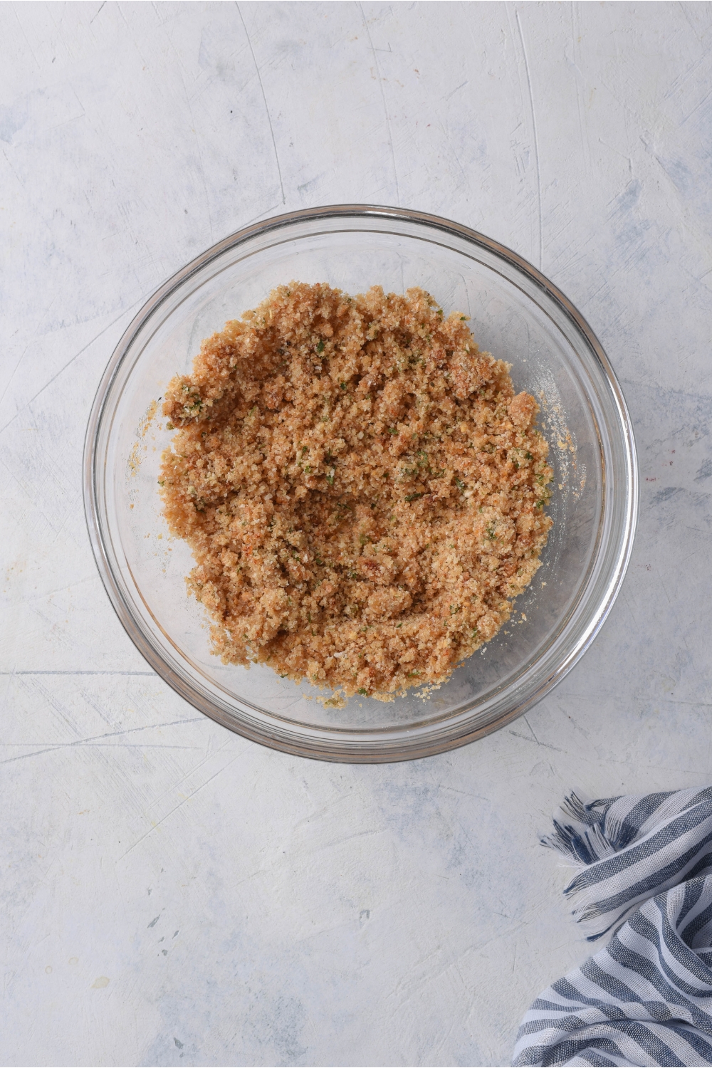 A clear bowl with a homemade seasoning and bread crumb mixture in it.