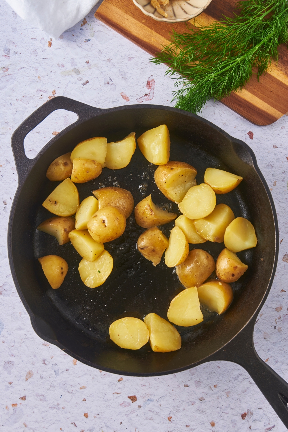 A cast iron skillet filled with sliced potatoes.