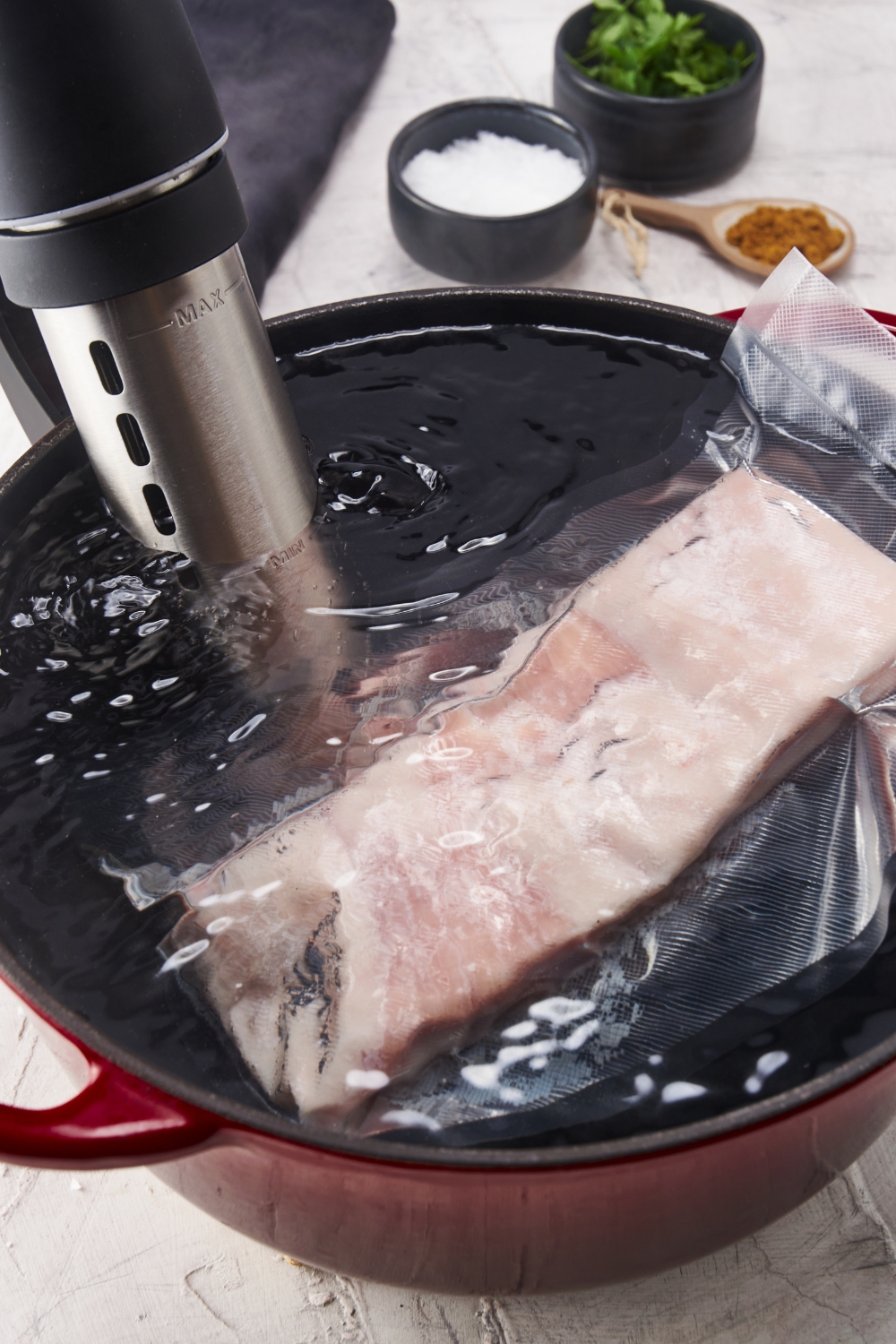 Pork belly in a vacuum sealed bag being cooked in a sous vide water bath.