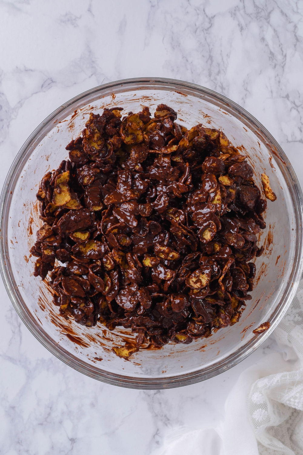 An overhead view of cornflakes completely covered with chocolate.