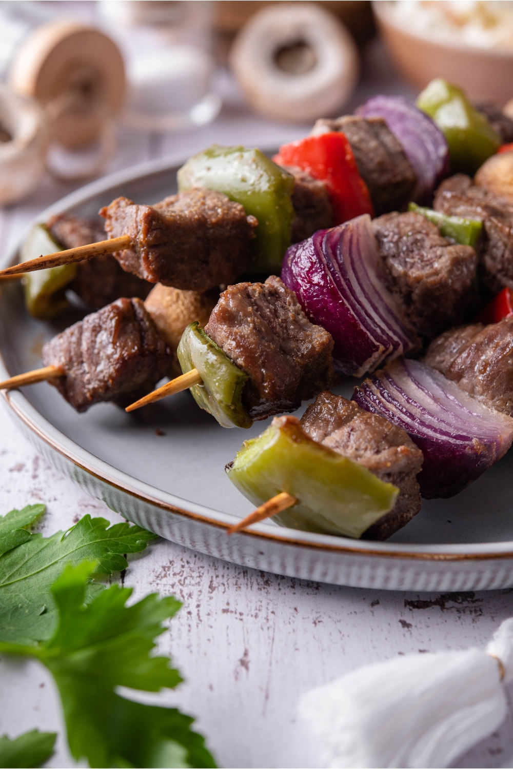 Close up of cooked steak and vegetable skewers.