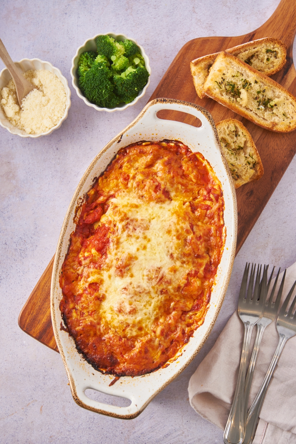 Baking dish filled with freshly baked ravioli covered in melted cheese.