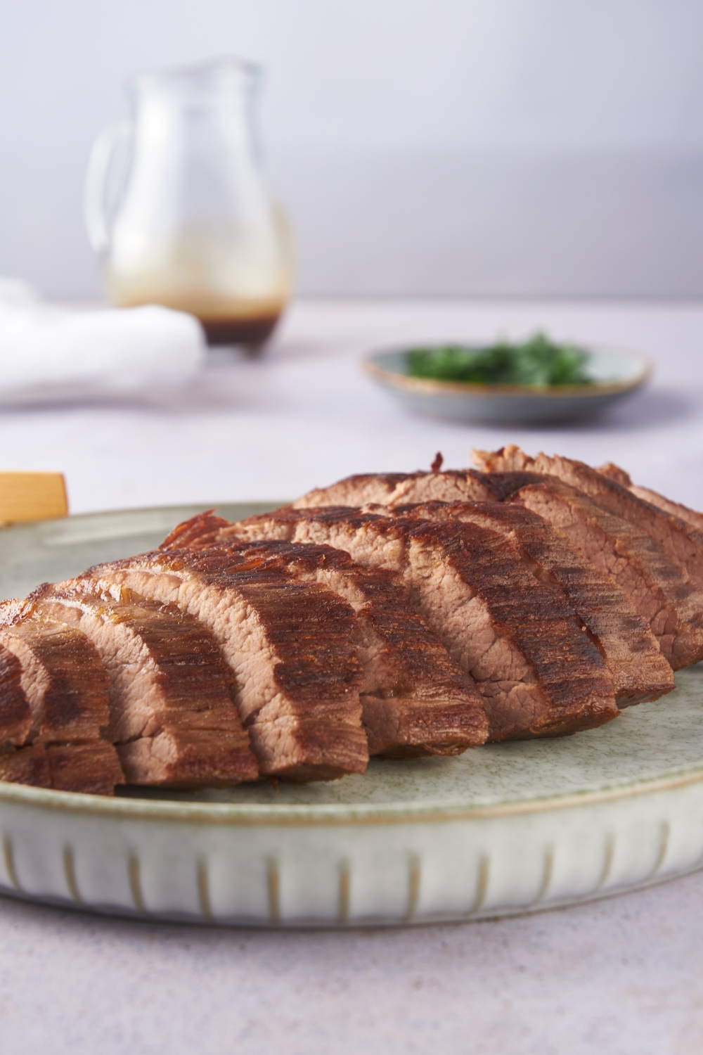 Close up of London broil sliced thin on a plate.