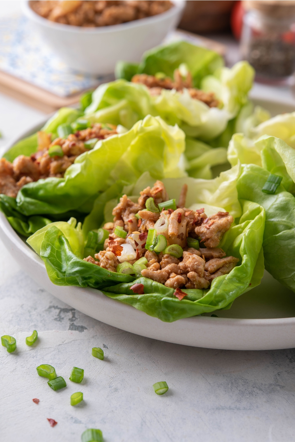 Close up of lettuce wraps stuffed with ground turkey, brazil nuts, and diced green onion.