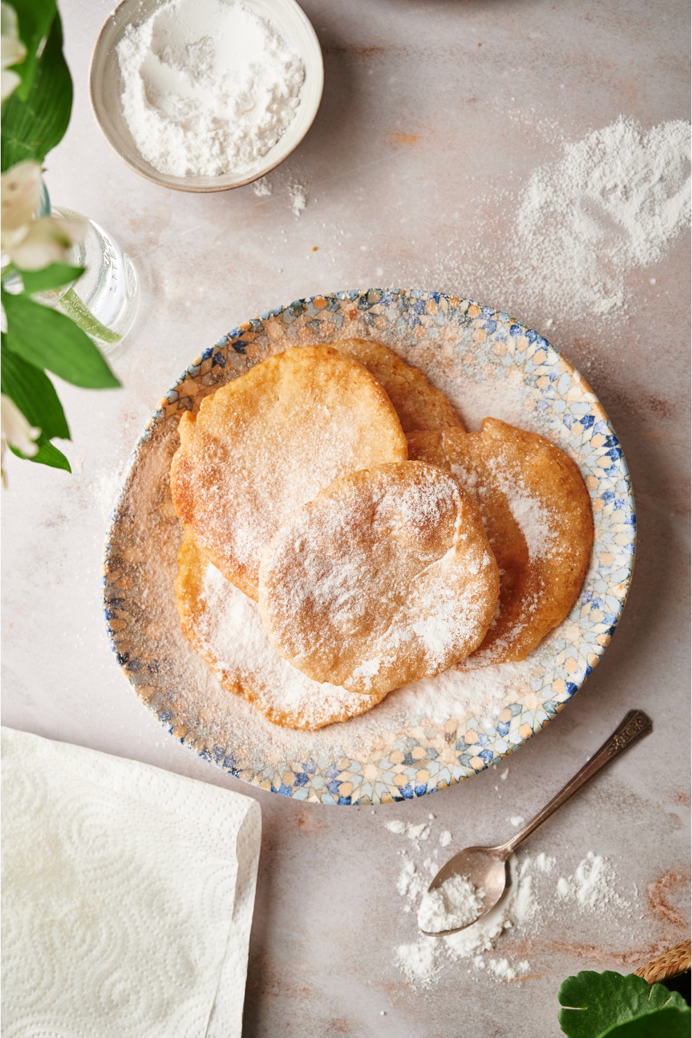 A bunch of pieces of fried dough on top of a plate on a table.